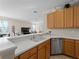 Clean kitchen with white countertops, stainless steel dishwasher, and wooden cabinets at 4153 Lenox Blvd, Venice, FL 34293