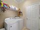 Laundry room with washer, dryer, and shelving at 4153 Lenox Blvd, Venice, FL 34293