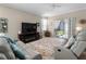 Living room with couches, TV, fireplace and access to backyard at 4153 Lenox Blvd, Venice, FL 34293