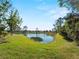 Scenic pond view with lush green landscaping at 4153 Lenox Blvd, Venice, FL 34293