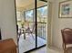 Private screened balcony overlooking a pond with patio furniture at 4515 45Th W Ave # 201A, Bradenton, FL 34210