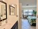 Bathroom with vanity, mirror, and view into bedroom at 4515 45Th W Ave # 201A, Bradenton, FL 34210
