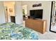 King-size bed, dresser with TV, and view into bathroom and living room at 4515 45Th W Ave # 201A, Bradenton, FL 34210