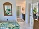 Main bedroom with tropical bedding, ensuite bathroom access, and dresser at 4515 45Th W Ave # 201A, Bradenton, FL 34210