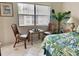 Bedroom sitting area with two chairs and a small table near window at 4515 45Th W Ave # 201A, Bradenton, FL 34210