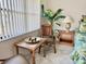 Bedroom sitting area with wicker chairs, side table, and leafy plant at 4515 45Th W Ave # 201A, Bradenton, FL 34210