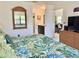 Main bedroom with tropical bedding, ensuite bathroom access, and dresser at 4515 45Th W Ave # 201A, Bradenton, FL 34210