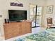 Bedroom with large dresser, TV, and sliding doors to balcony at 4515 45Th W Ave # 201A, Bradenton, FL 34210