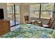 Bedroom with balcony access, sitting area, and view from window at 4515 45Th W Ave # 201A, Bradenton, FL 34210