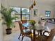 Bright dining area with glass table and wicker chairs, overlooking a scenic view at 4515 45Th W Ave # 201A, Bradenton, FL 34210