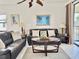 Relaxing living room with leather sofas, coffee table, and access to balcony at 4515 45Th W Ave # 201A, Bradenton, FL 34210