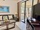 Spacious living room with leather couches, balcony access, and canal view at 4515 45Th W Ave # 201A, Bradenton, FL 34210