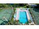 Community pool with lounge chairs and tennis courts nearby at 4515 45Th W Ave # 201A, Bradenton, FL 34210