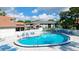 Kidney shaped community pool with lounge chairs at 4515 45Th W Ave # 201A, Bradenton, FL 34210