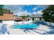 Kidney shaped community pool with lounge chairs at 4515 45Th W Ave # 201A, Bradenton, FL 34210