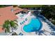 Relaxing kidney-shaped pool and spa with surrounding lounge chairs at 4515 45Th W Ave # 201A, Bradenton, FL 34210