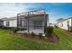 Well-manicured backyard with a covered patio area, perfect for relaxation and outdoor enjoyment at 4739 Willow Bend Ave, Parrish, FL 34219