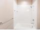 Bright bathroom featuring a white tiled shower-over-tub with chrome hardware at 4739 Willow Bend Ave, Parrish, FL 34219