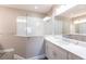 Bright bathroom featuring a double sink vanity with gray cabinetry and a glass-enclosed shower at 4739 Willow Bend Ave, Parrish, FL 34219