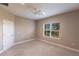 Neutral bedroom features a ceiling fan, base trim, a window with an outdoor view, and a white interior door at 4739 Willow Bend Ave, Parrish, FL 34219