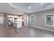 A spacious kitchen with white cabinets, stainless steel appliances, a center island, and gray flooring at 4739 Willow Bend Ave, Parrish, FL 34219