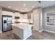 Spacious kitchen with stainless steel appliances, a central island with a white countertop, and gray flooring at 4739 Willow Bend Ave, Parrish, FL 34219