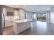A kitchen with stainless steel appliances, a large island with a white countertop, and a dining area at 4739 Willow Bend Ave, Parrish, FL 34219