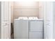 Neat laundry area with a side-by-side washer and dryer, and a wire shelf for added storage at 4739 Willow Bend Ave, Parrish, FL 34219