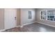 A living room with gray floors, a window with blinds, and a door to the outside at 4739 Willow Bend Ave, Parrish, FL 34219