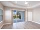 Main bedroom with gray flooring, a ceiling fan, and sliding glass doors to an outdoor space at 4739 Willow Bend Ave, Parrish, FL 34219