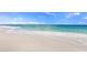 White sand beach with gentle waves and blue sky at 504 Gulf St, Venice, FL 34285