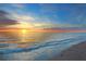 Stunning sunset over the ocean with waves gently lapping the shore at 504 Gulf St, Venice, FL 34285