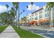 Street view of shops and restaurants with palm trees and sidewalk at 504 Gulf St, Venice, FL 34285