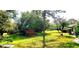Landscaped backyard with lush greenery and mature trees, providing a serene outdoor space at 5244 Marsh Field Rd # 6, Sarasota, FL 34235
