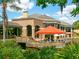 Outdoor patio area with seating and a retractable awning, overlooking a pond at 5244 Marsh Field Rd # 6, Sarasota, FL 34235