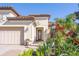 Front entrance with double doors and decorative landscaping at 5247 Esplanade Blvd, Bradenton, FL 34211