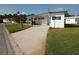 White single-wide manufactured home with covered carport and landscaped yard at 5330 Rancho Ave, Sarasota, FL 34234