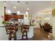 Well-lit kitchen with granite countertops, dark wood cabinets, stainless steel appliances, and adjacent dining room at 5814 Cavano Dr, Sarasota, FL 34231