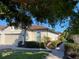 Tan single-Gathering home with tile roof, two-car garage, and landscaped walkway at 5814 Cavano Dr, Sarasota, FL 34231