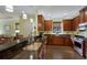 Well-lit kitchen with granite countertops, dark wood cabinets, stainless steel appliances, and a breakfast bar area at 5814 Cavano Dr, Sarasota, FL 34231