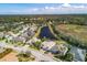 Overhead aerial shot of a residential neighborhood with homes surrounding a pond and lush landscape at 611 Dogwood Run, Bradenton, FL 34212