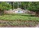 Beautiful community sign, surrounded by a manicured, landscaped lawn and mature trees at 611 Dogwood Run, Bradenton, FL 34212