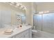 Bathroom with tiled shower, single sink vanity, and decorative accents at 6211 Skyward Ct, Bradenton, FL 34203