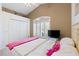 Nicely decorated bedroom featuring shutters and a television, along with white trim at 6211 Skyward Ct, Bradenton, FL 34203