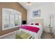Bright bedroom with large window and shutters, a ceiling fan and light fixture at 6211 Skyward Ct, Bradenton, FL 34203