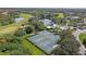 Scenic aerial shot featuring a golf course, pool, tennis courts, clubhouse, and beautiful landscaping, promoting a luxurious lifestyle at 6211 Skyward Ct, Bradenton, FL 34203