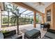 Screened-in lanai with comfortable seating and tile flooring at 6211 Skyward Ct, Bradenton, FL 34203