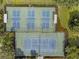 Aerial view of well-maintained pickleball and tennis courts surrounded by lush landscaping, providing a recreational amenity at 6211 Skyward Ct, Bradenton, FL 34203