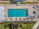 Aerial view of a pool with lounge chairs, surrounding foliage, and a spa at 6211 Skyward Ct, Bradenton, FL 34203
