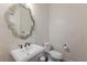 Powder room with decorative mirror and pedestal sink at 629 Wildlife Gln, Bradenton, FL 34209